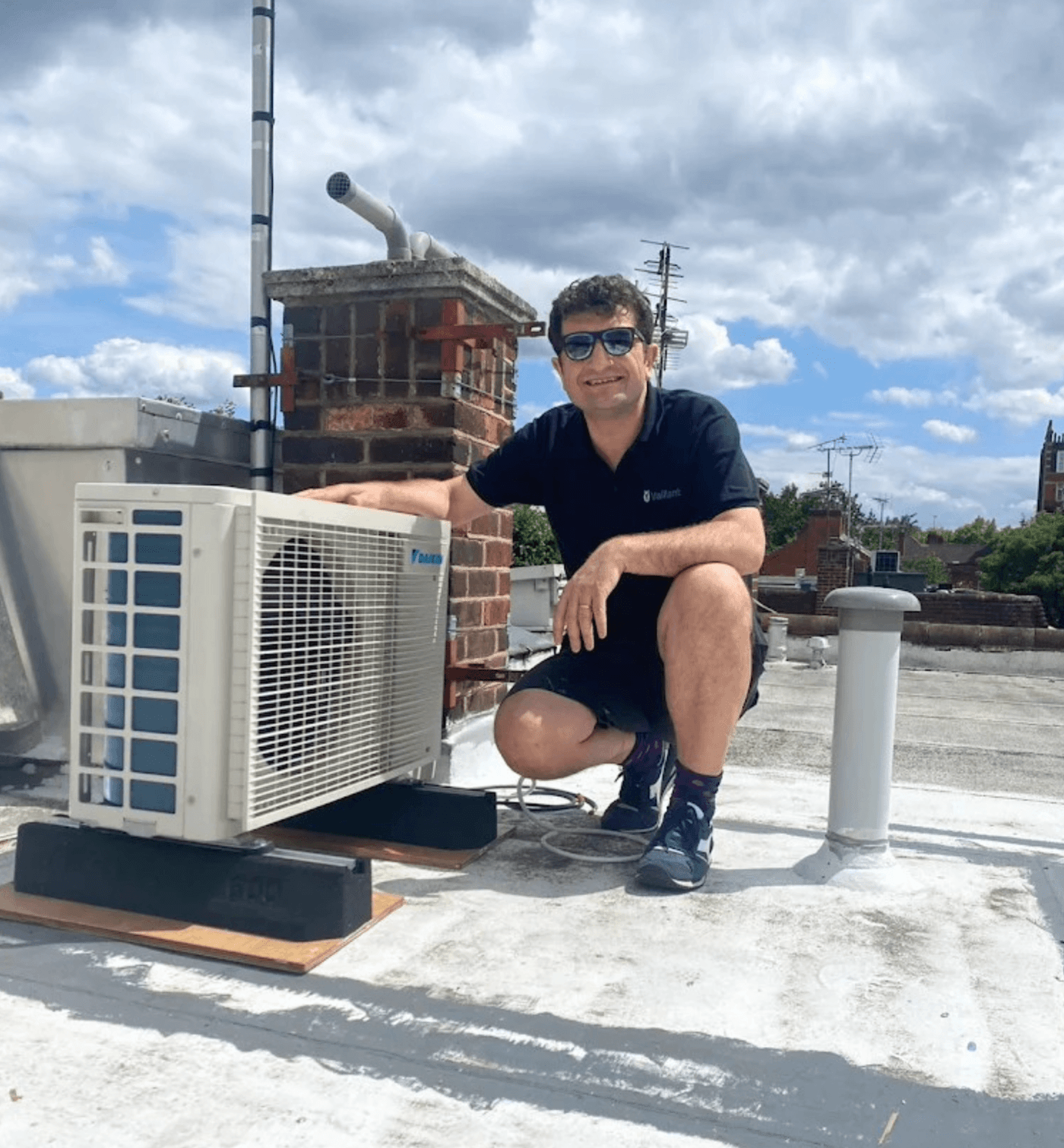 Alex Maku, founder of AM Heating & Renewable, working on a heating system in London