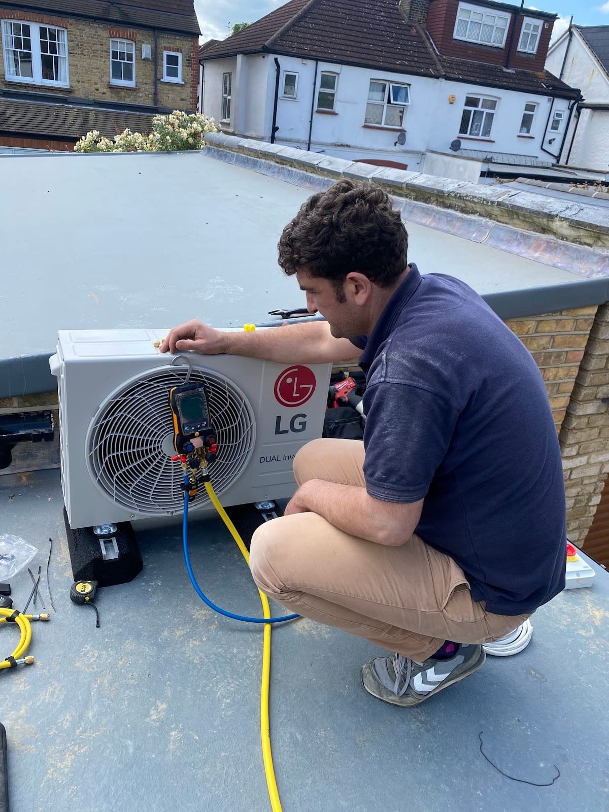 Alex commissioning an LG outdoor air conditioning unit on a London rooftop