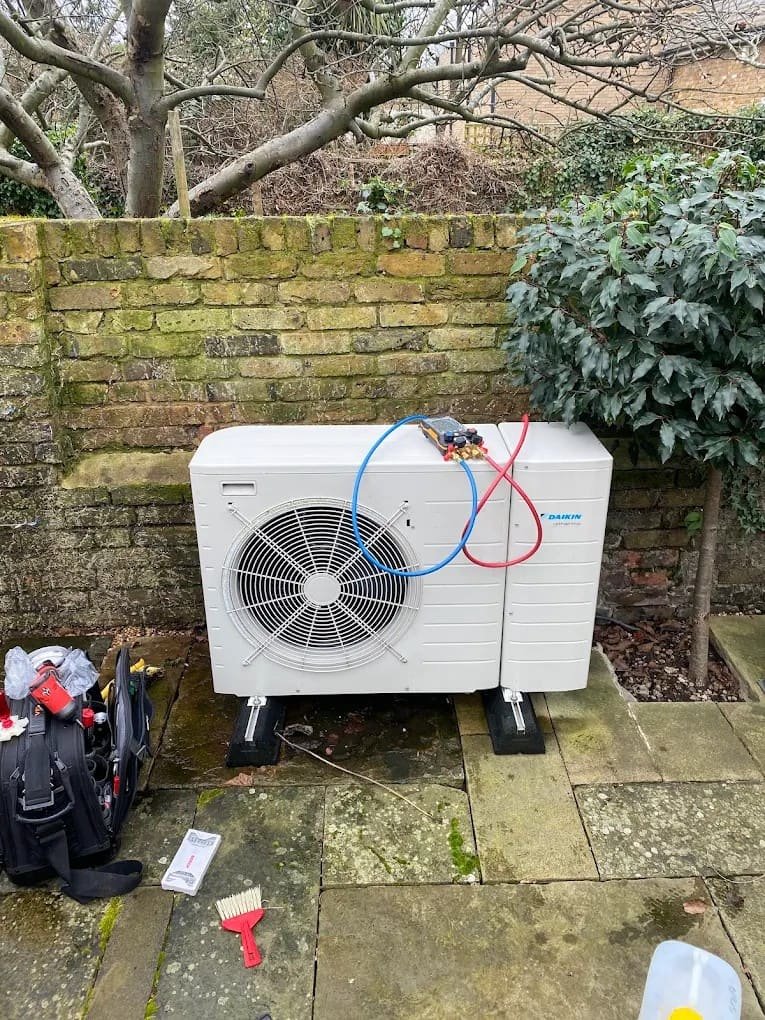 Outdoor air conditioning condenser unit installed in a London garden