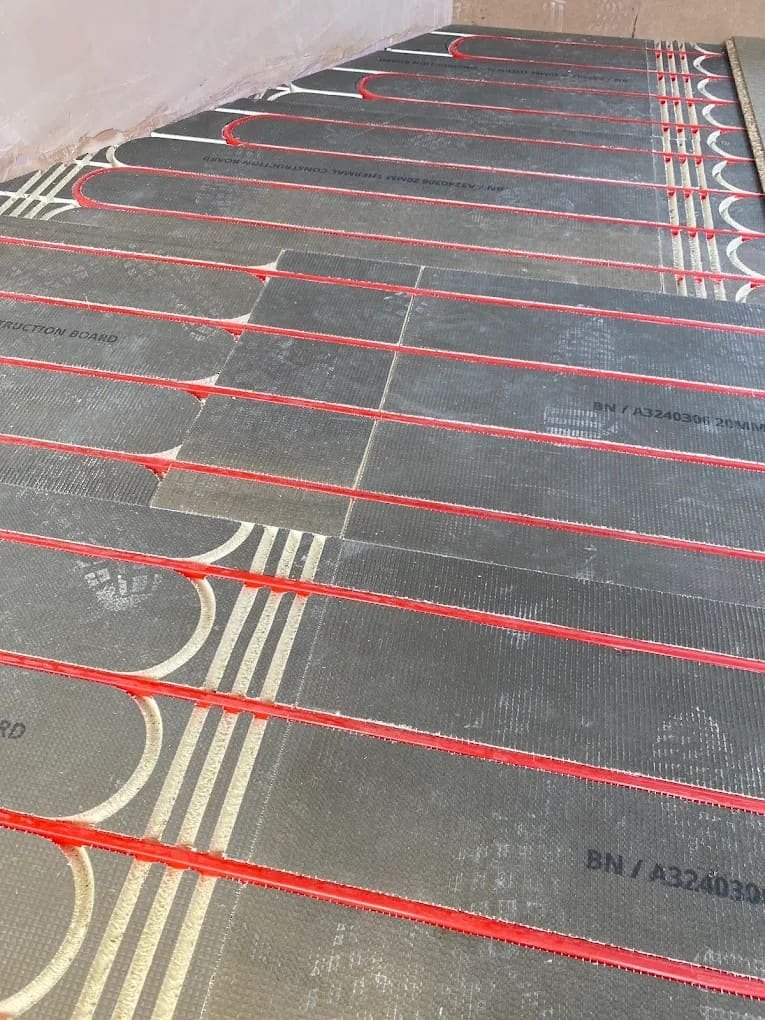 Underfloor heating pipework being laid before screed